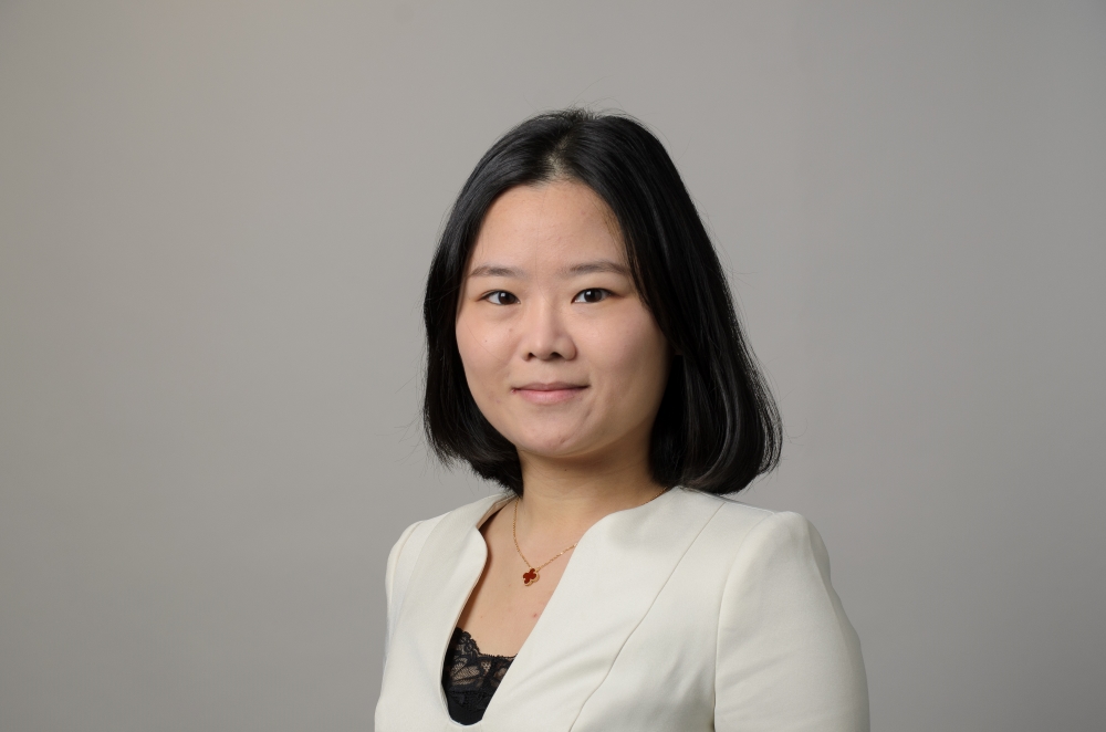 Portrait of Zhuomin Chen wearing a white blouse.